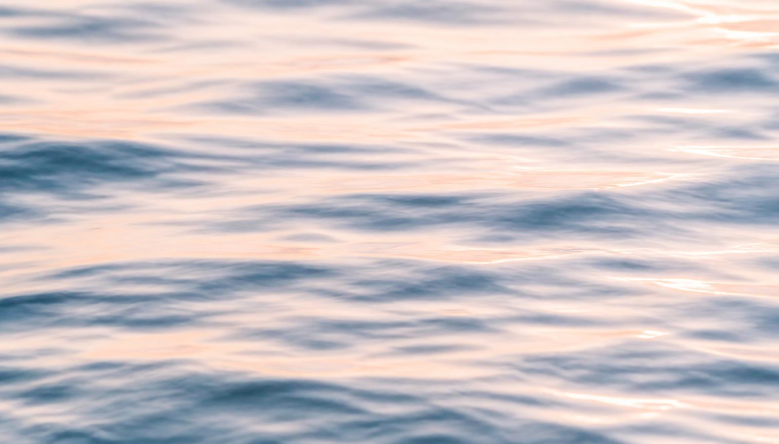 Sunlight rippling across calm ocean water